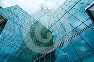 Modern sustainable green glass office building. Exterior view of corporate headquarters glass building architecture. Energy-