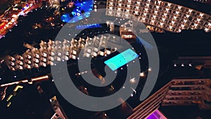 modern swimming pool with blue water illumination on hotel roof top, Tenerife