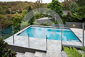 Modern swimming pool with a glass fence on the floor