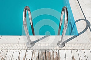 Modern swimming pool with ladder at