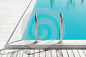 Modern swimming pool with ladder at