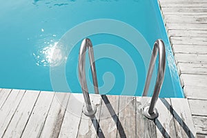 Modern swimming pool with ladder