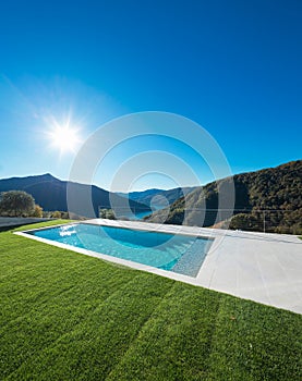 Modern swimming pool with lake and valley view