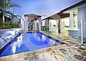 Modern swimming pool side with glass cover at night