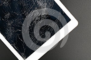 Modern tablet pc with highly broken screen on black background