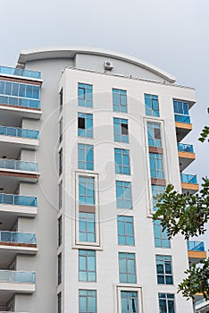 Modern tall residential apartment building with French windows