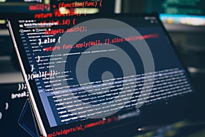 Modern tech. PHP syntax highlighted. Writing programming functions on laptop. Big data and Internet of things trend