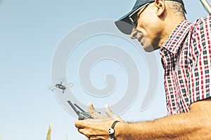 Modern technological farmer analyzing the growth of corn by flying a drone