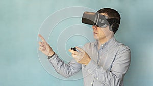 Modern technologies and domestic entertainment concept. Young man trying virtual reality , using headset VR glasses and