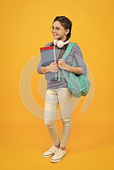 Modern technologies in education. Happy child back to school. Little girl wear headphones. Modern life. Music school