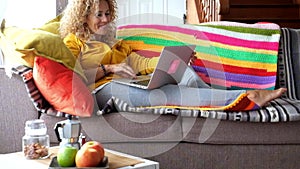 Modern technology adult woman at home with laptop computer internet connected - people and online shopping activity - online busin