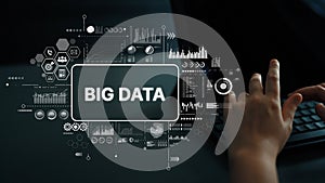 Modern Technology Concept with Big Data Visualization and Analytics on Computer Screen in Dark Office Environment