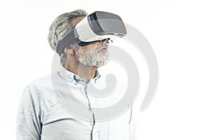 Modern technology concept. Silver-Haired caucasian adult man in a shirt wearing VR googles and looking on the side