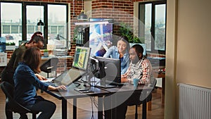 Modern technology studio employees using computers to develop new graphics
