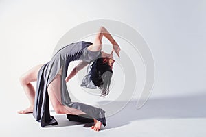 Modern teen contemporary dancer poses in front of the studio background.