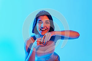 Modern teen contemporary dancer poses in front of the studio background.