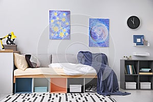 Modern teenager`s room interior with comfortable bed and stylish design elements