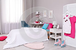 Modern teenager`s room interior with comfortable bed and workplace