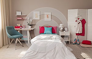 Modern teenager`s room interior with comfortable bed and workplace