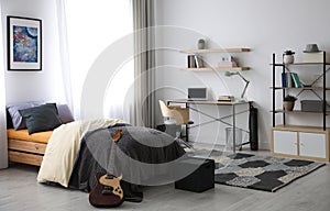 Modern teenager`s room with workplace and bed