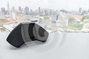 Modern of telephone IP conferance device on the white table with city scape view for teleconferance technology concept