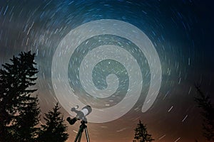 Modern telescope under night sky with star trails outdoors, low angle view. Learning astronomy