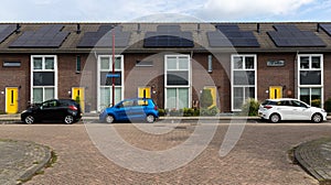 Modern Terraced houses with solar panels on the roof of rental houses. Photovoltaic panels on the roof.