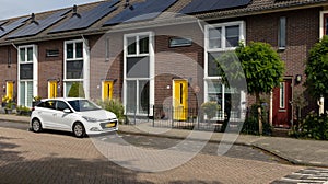 Modern Terraced houses with solar panels on the roof of rental houses. Photovoltaic panels on the roof.