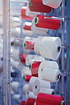 Modern Textile Factory. Rows of automated machines for yarn manufacturing.