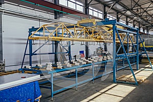 Modern thermal insulation sandwich panel production line. Machine tools, roller conveyor in workshop