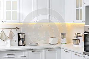 Modern toaster and other cooking appliances on countertop in kitchen