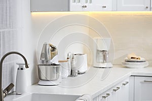 Modern toaster and other cooking appliances on countertop in kitchen