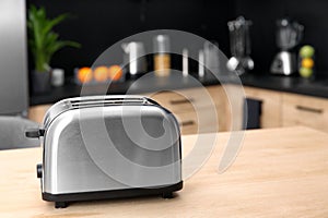 Modern toaster on table in kitchen