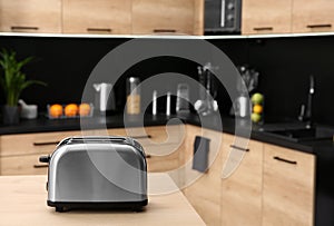 Modern toaster on table in kitchen