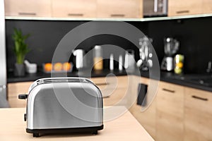 Modern toaster on table in kitchen