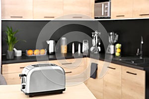 Modern toaster on table in kitchen