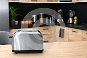 Modern toaster on table in kitchen