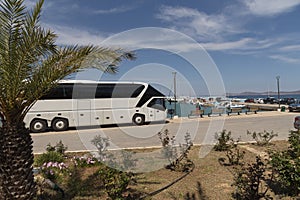 Modern tour bus on the seafront in Sitia an eastern Crete resort.