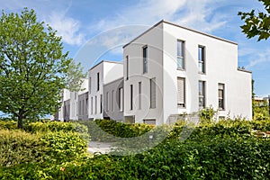 Modern townhouses in a residential area, new apartment buildings with green outdoor facilities in the city photo