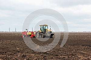 Modern tractor on soil treated cultivator in the field
