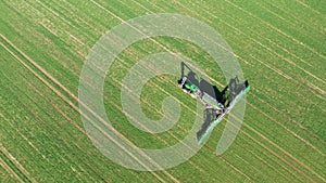 modern tractor with a trailer is working in a field