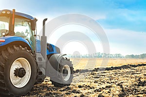 Modern tractor working in a field.