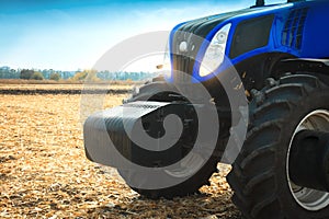 Modern tractor working in a field close-up.