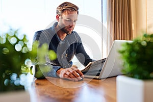 Modern trader working from home at his dining table