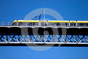 Modern tram on a steel bridge