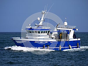 Modern Trawler Underway at Sea. photo