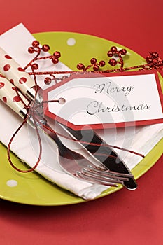 Modern trend lime green and red Merry Christmas table place setting. Vertical