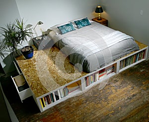 Modern trendy bedroom with bed on a platform