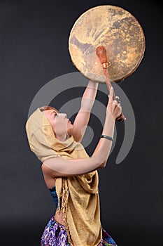 Modern Tribal Woman playing a drum