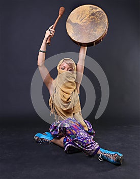 Modern Tribal Woman playing a drum